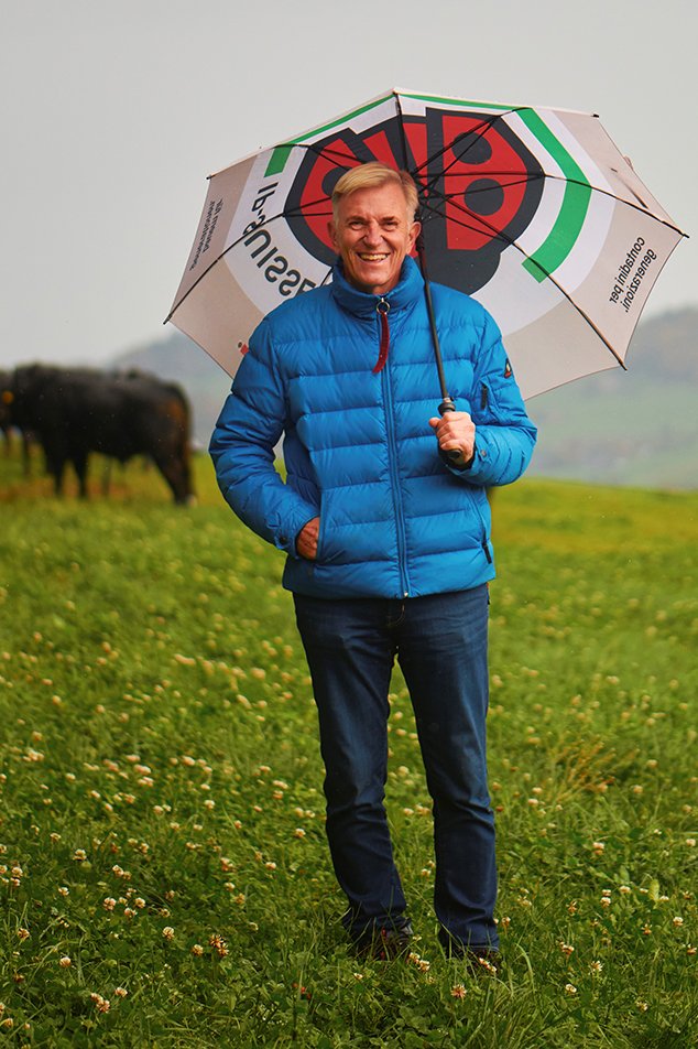 daniel niklaus auf Wiese mit Regenschirm